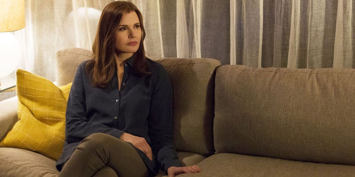 Geena Davis sitting on a couch.