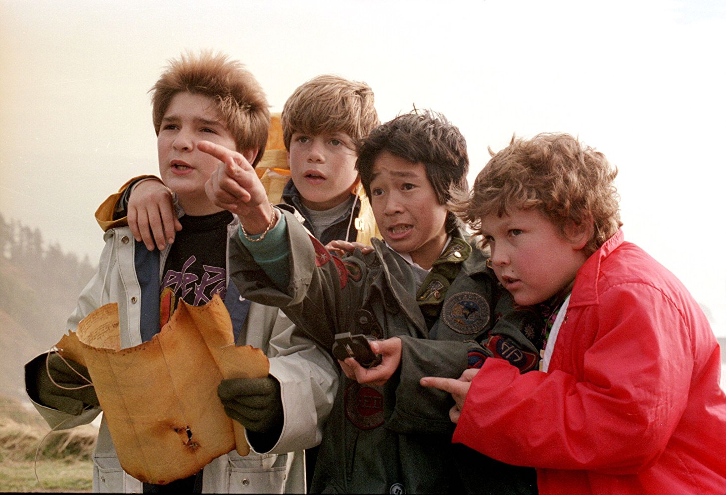 Still of Corey Feldman, Sean Astin, Ke Huy Quan, and Jeff Cohen from The Goonies, 1985.