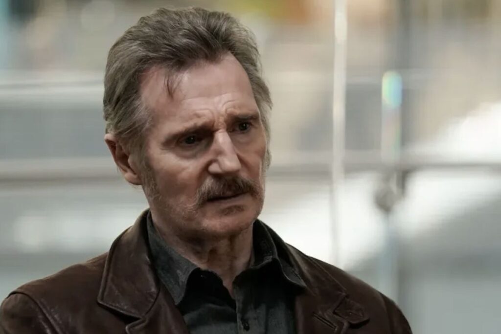 Closeup of Liam Neeson with a mustache.