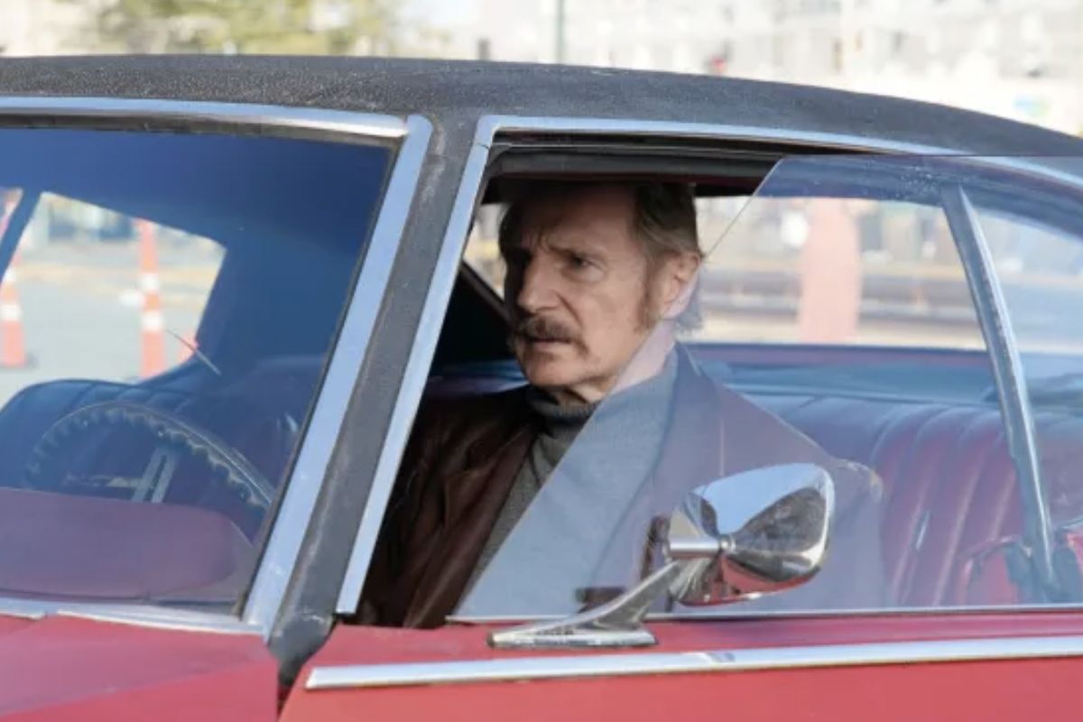 Liam Neeson driving a red car in Absolution.