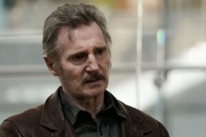 Closeup of Liam Neeson with a mustache.