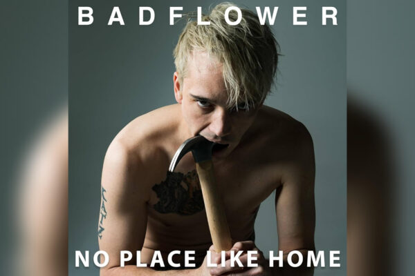 Badflower’s ‘No Place Like Home’ Digs Deep — Album Review Album cover for Badflower's "No Place Like Home," featuring lead vocalist Josh Katz posing shirtless while sticking a hammer in his mouth on a gray background.