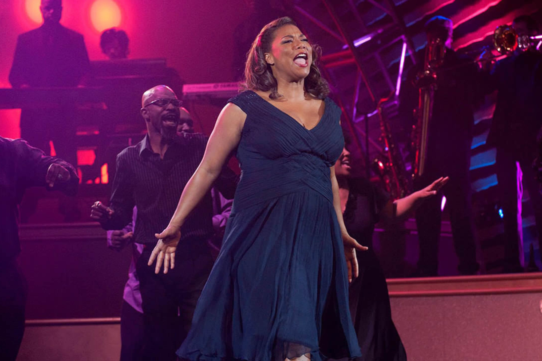 Queen Latifah as Vi Rose Hill singing on stage with choir in Joyful Noise