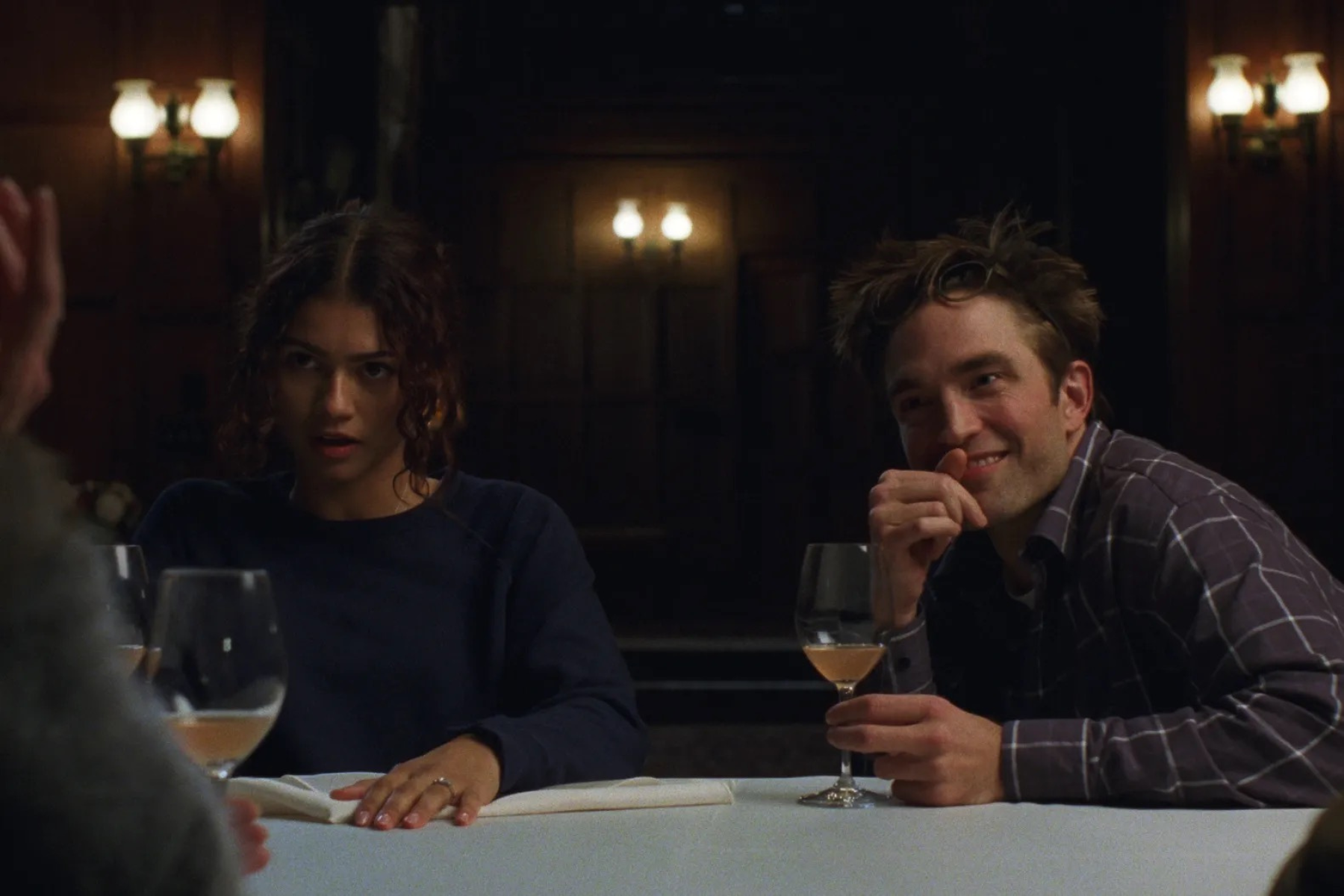 Zendaya as Emma and Robert Pattinson as Charlie in The Drama. (Photo courtesy of A24). Zendaya looks uneasy while Robert Pattinson smiles during a tense dinner conversation