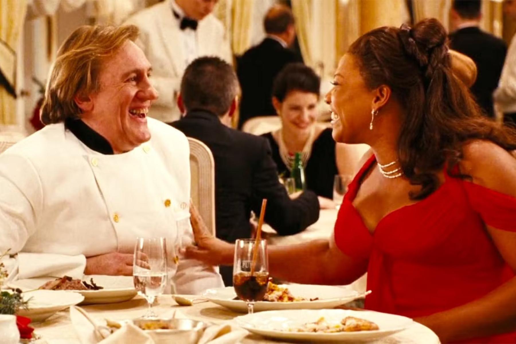 Queen Latifah as Georgia Byrd smiling at dinner in Last Holiday