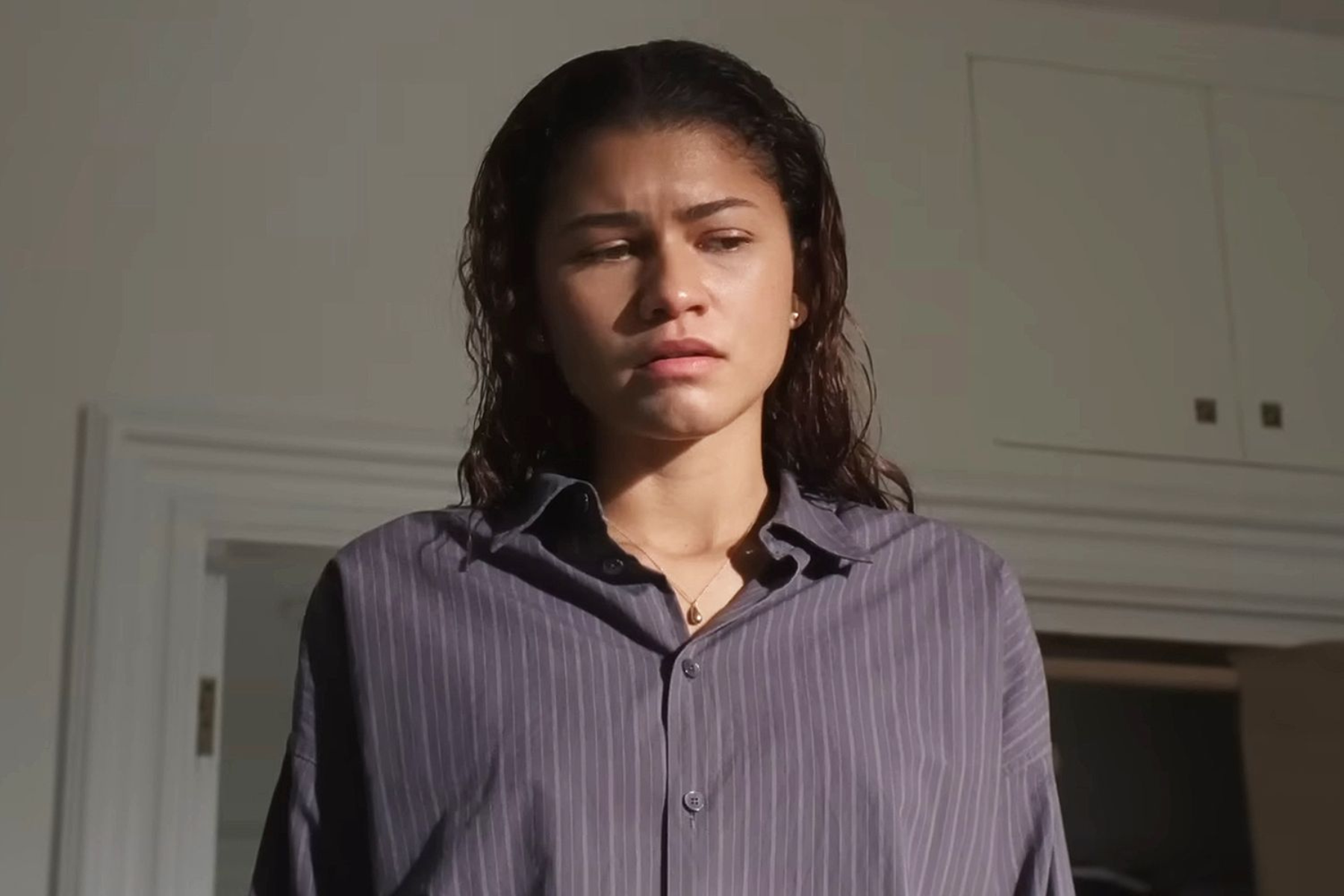 Zendaya as Emma in The Drama (Photo courtesy of A24). Zendaya stands alone in a sunlit room, looking troubled and introspective