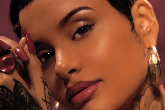 Kehlani Album Review: A Self-Titled Era That Feels Right Close-up album cover image of Kehlani with short hair, glossy makeup, and hand tattoos, posing against a warm-toned background.