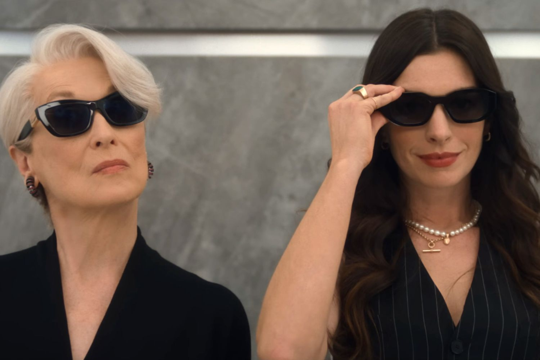 The Devil Wears Prada 2 Review: A Stunning Return to Runway Miranda and Andy wear sunglasses, standing side by side with confidence