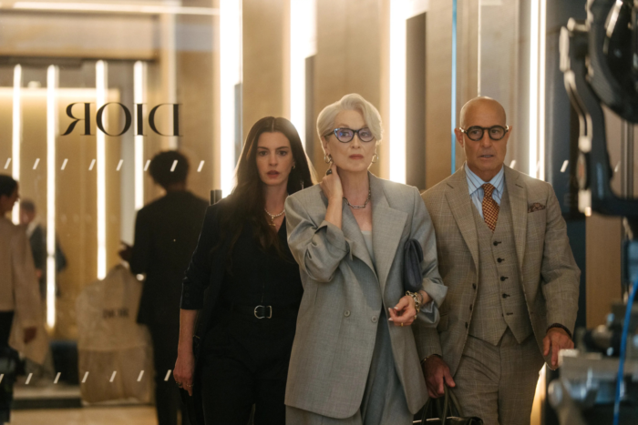 Miranda, Andy and Nigel walk through a high-fashion office space together