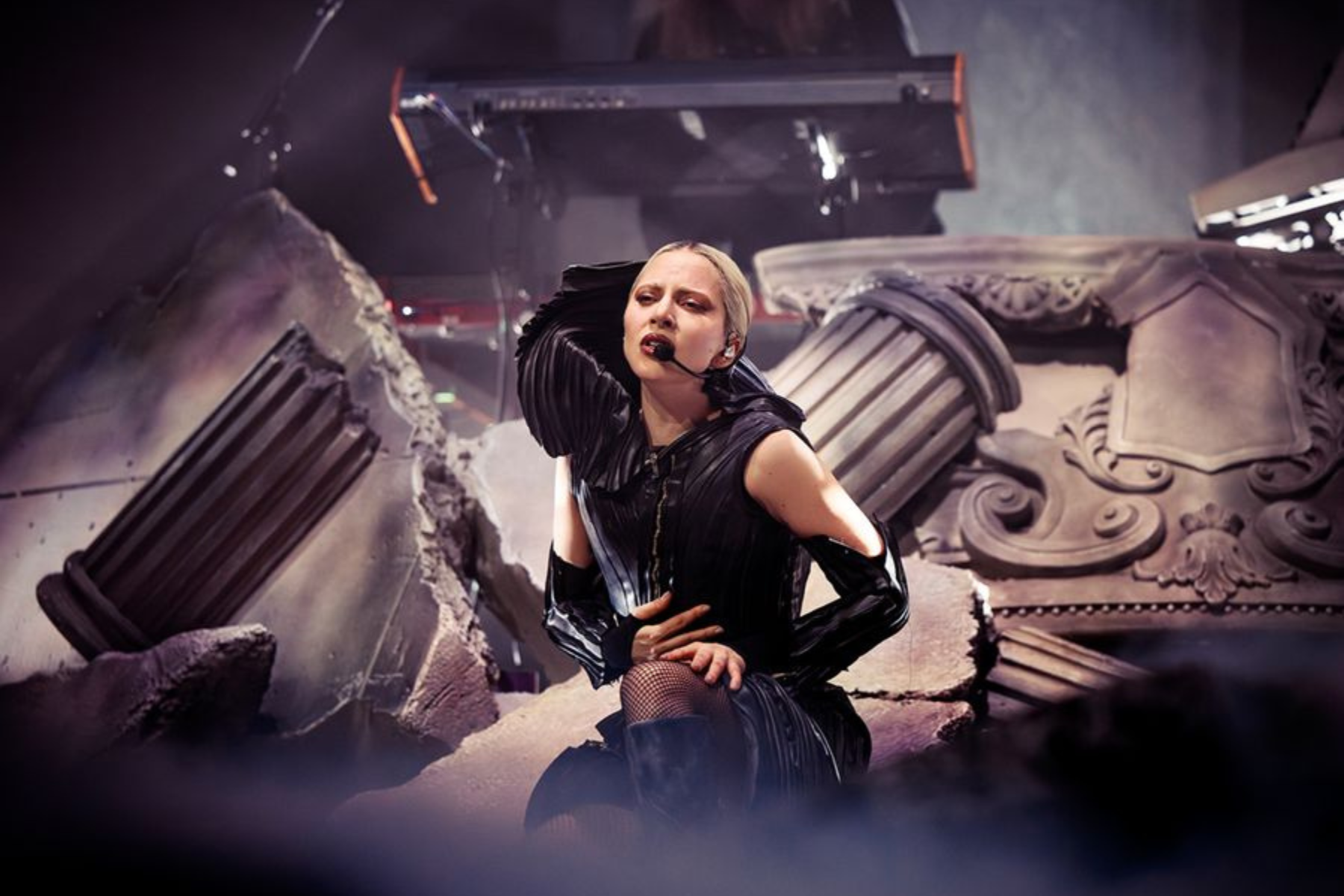Lady Gaga MAYHEM Requiem Review: Visually Stunning, Vocally Flawless Lady Gaga performs onstage in a black outfit surrounded by crumbling stone ruins during MAYHEM Requiem