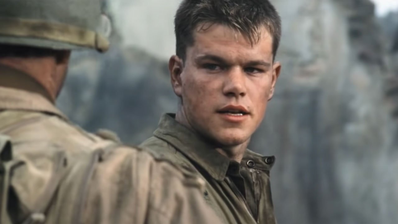 The 12 Best Movies Featuring Matt Damon in a Principal Role Young soldier with short brown hair looks over his shoulder while talking to a comrade on a battlefield, wearing a dusty uniform.