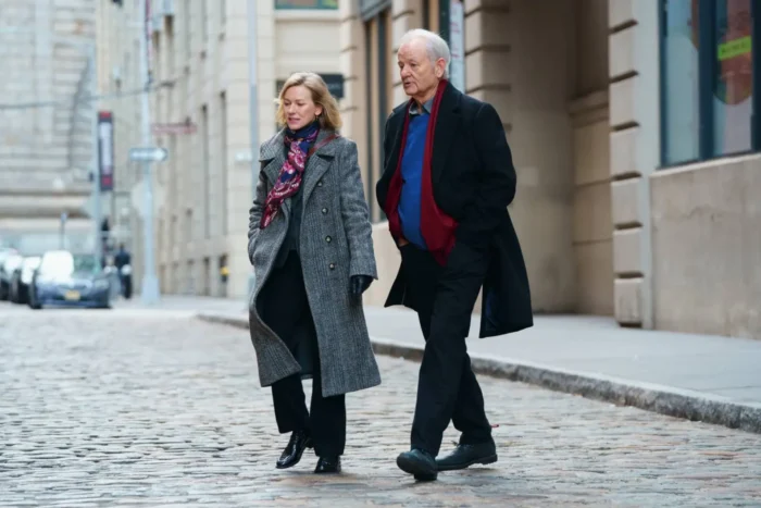 The 12 Greatest Movies Featuring Bill Murray Two seniors walking side by side on a cobblestone city street in coats and scarves