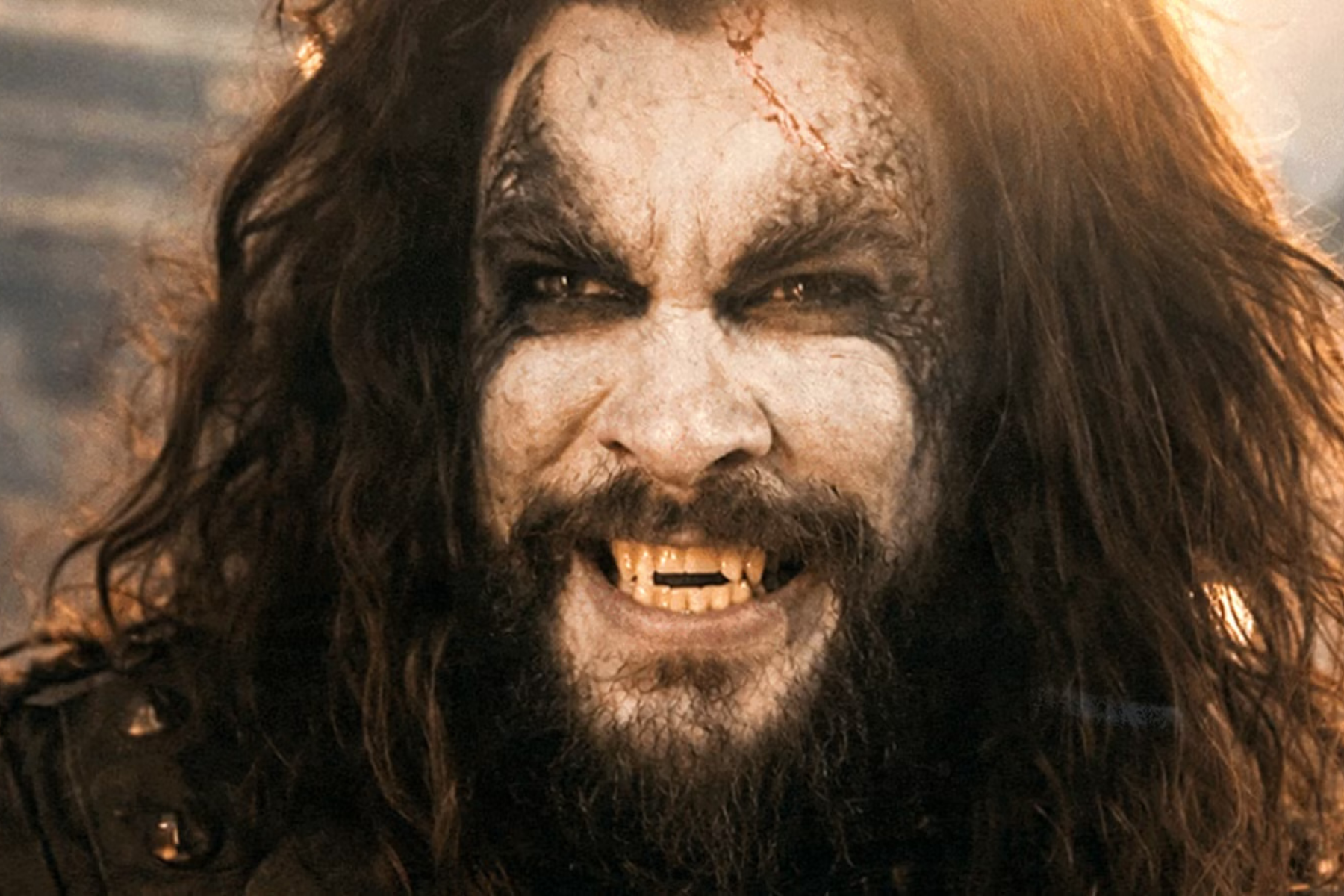 Supergirl Review: Strong Performances Can’t Save an Uneven Adventure Close-up of a pale, snarling vampire-like man with long hair, dark eyes, and sharp fangs showing.