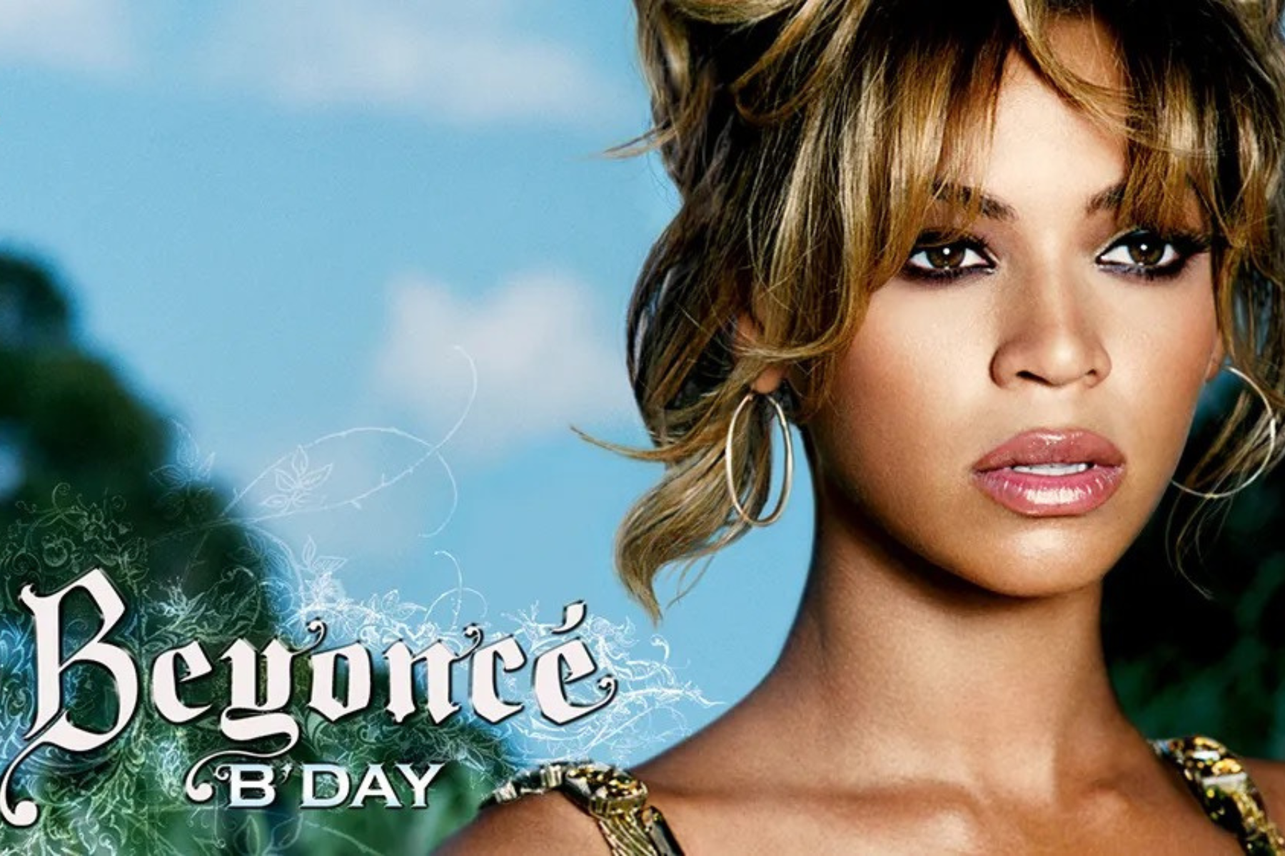 Every Beyoncé Album – Ranked! Close-up portrait of a woman with bold makeup and hoop earrings against a blue sky background, with decorative floral graphics and partial magazine title text overlapping.