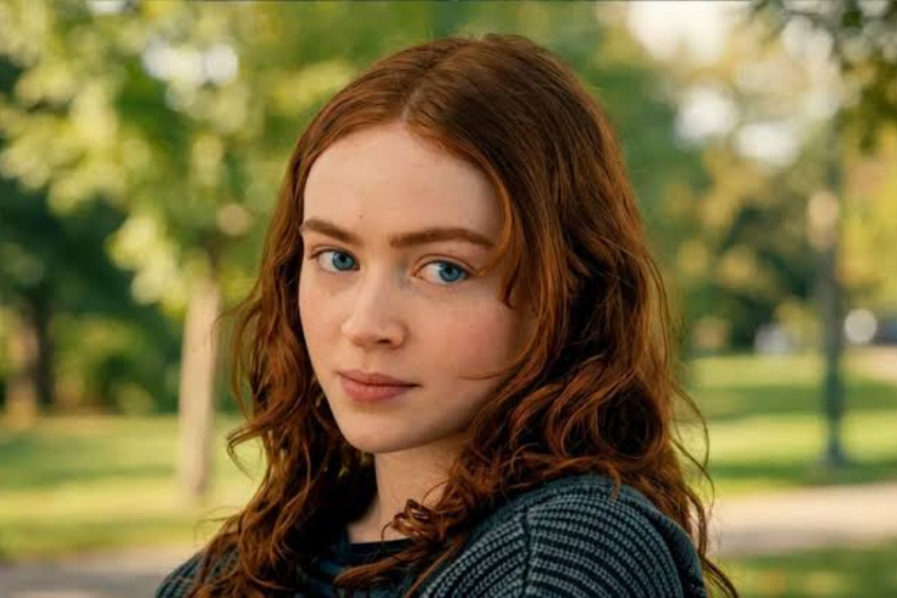 Spider-Man: Brand New Day Review: The Hero Marvel Needed Portrait of a young woman with wavy red hair outdoors in a park, looking at the camera.