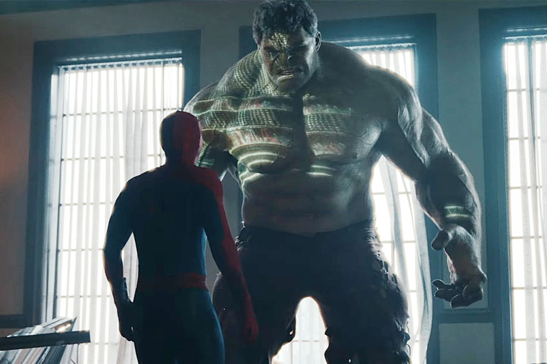 Spider-Man: Brand New Day Review: The Hero Marvel Needed A huge, green, muscular creature confronts a person in a red cape indoors near tall, sunlit windows.