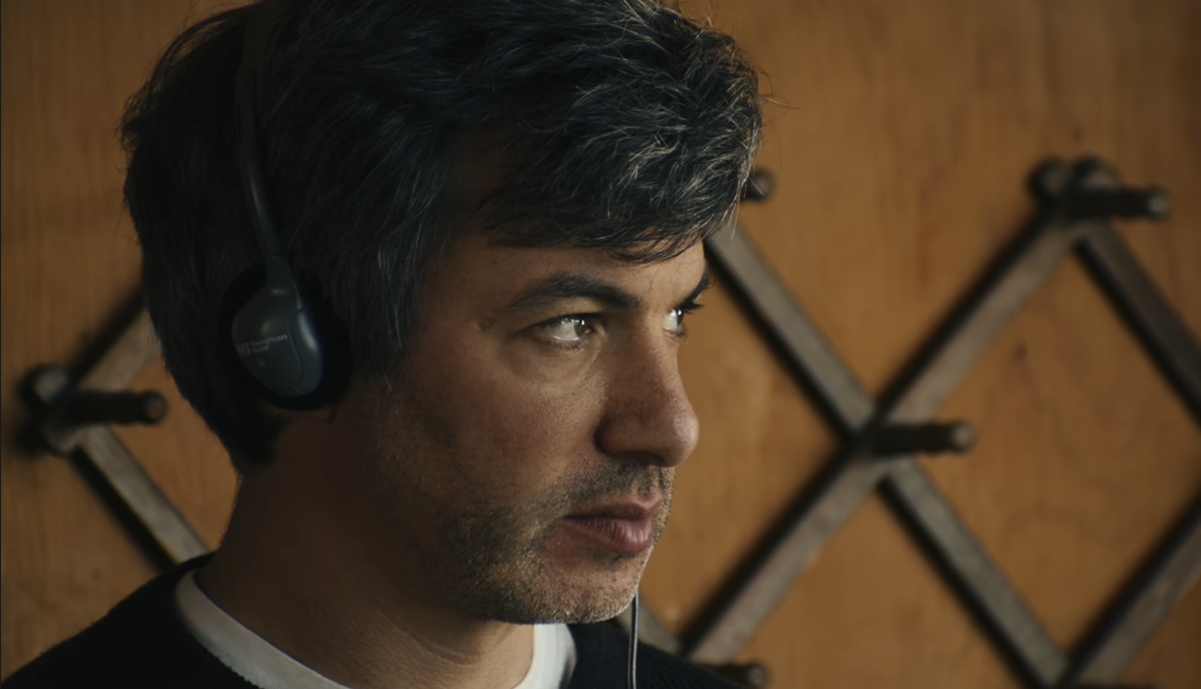 You Can See Everything Review: The Truth Is Not As Simple As It Seems A man wearing headphones staring into the distance